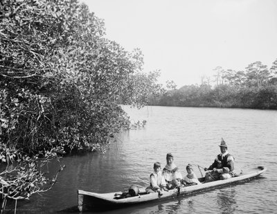 Seminole Indian and Family Dugout Canoe, Miami, Florida, c.1910-20 by Detroit Publishing Co.
